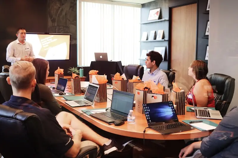 Business team attending a presentation around a conference table